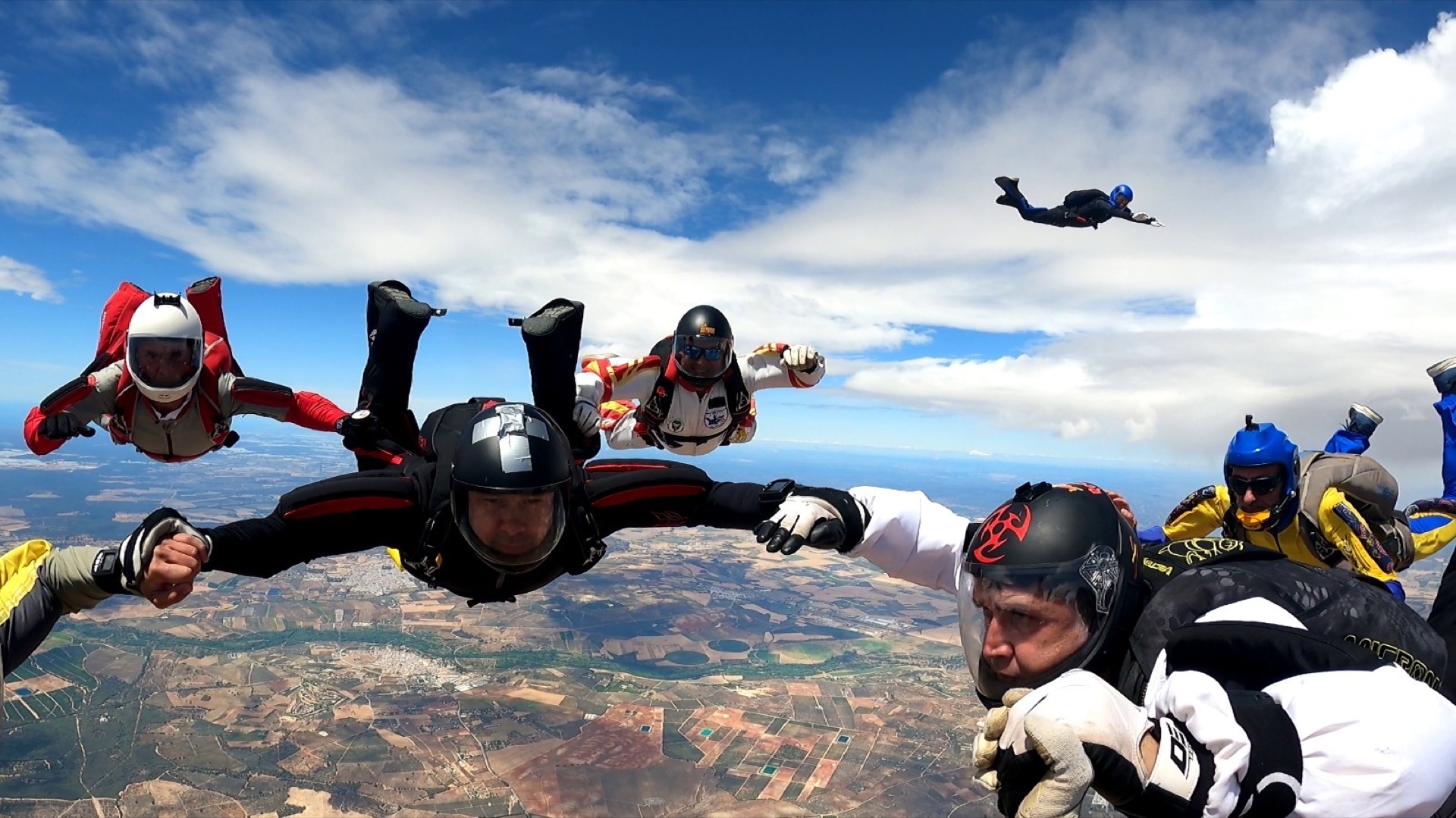 Skydivers gripped up in freefall, seen from inside the formation