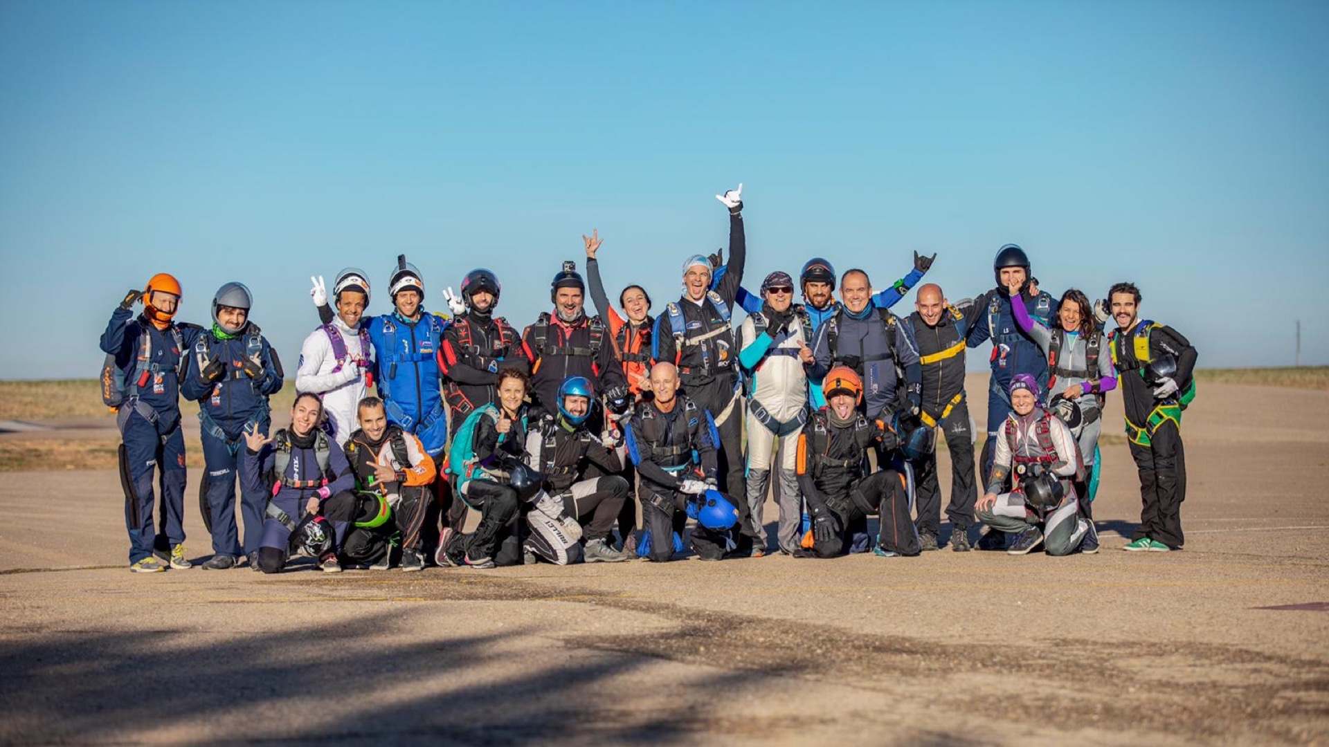A group of skydivers on the runway after a jump